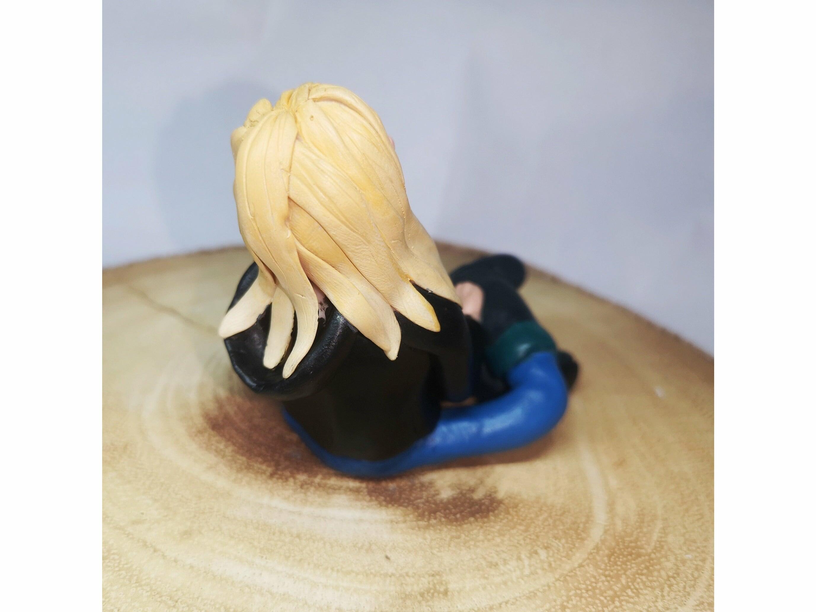 A zoomed in photo of a clay model of a blonde girl showing the detail of the sculpting of her hair