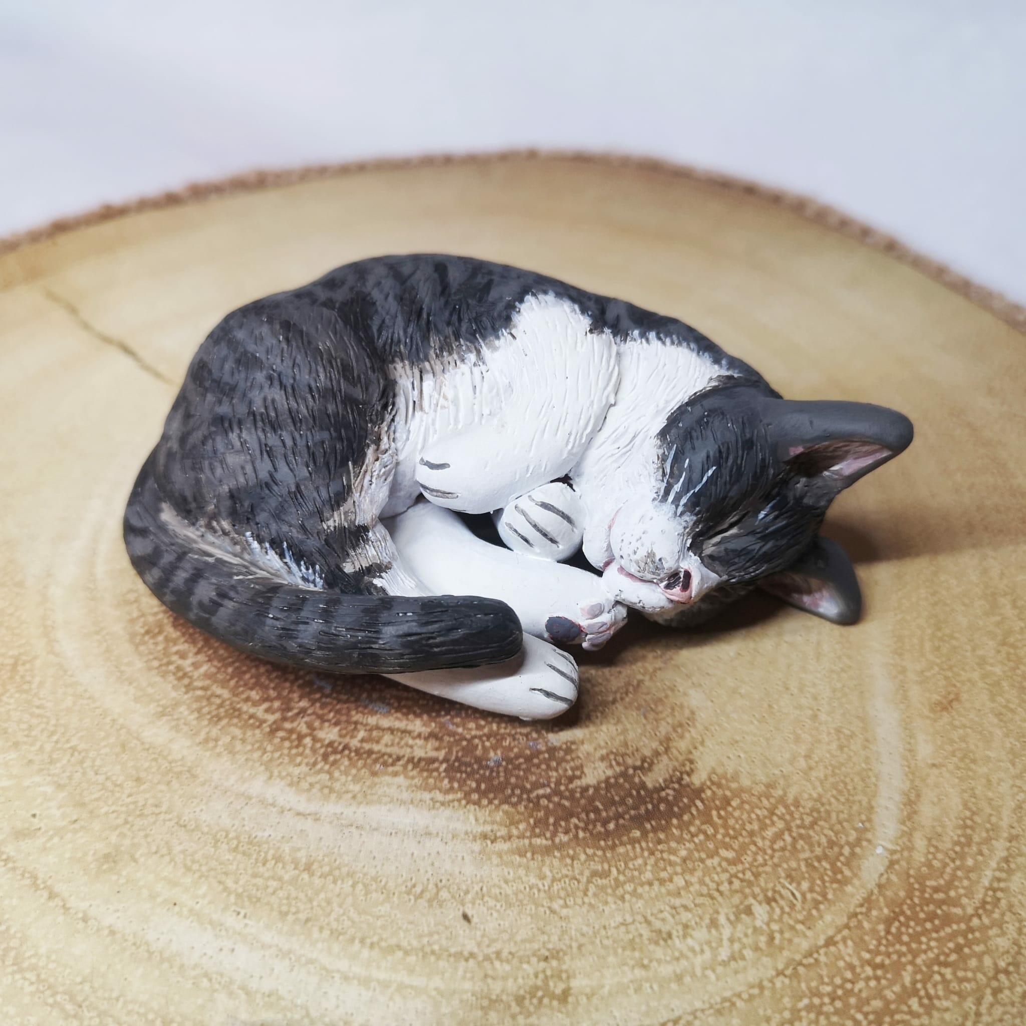 Handmade and handpainted clay model of a sleeping cat, crafted with love and attention to detail, showcasing the peaceful and serene state of your feline friend.