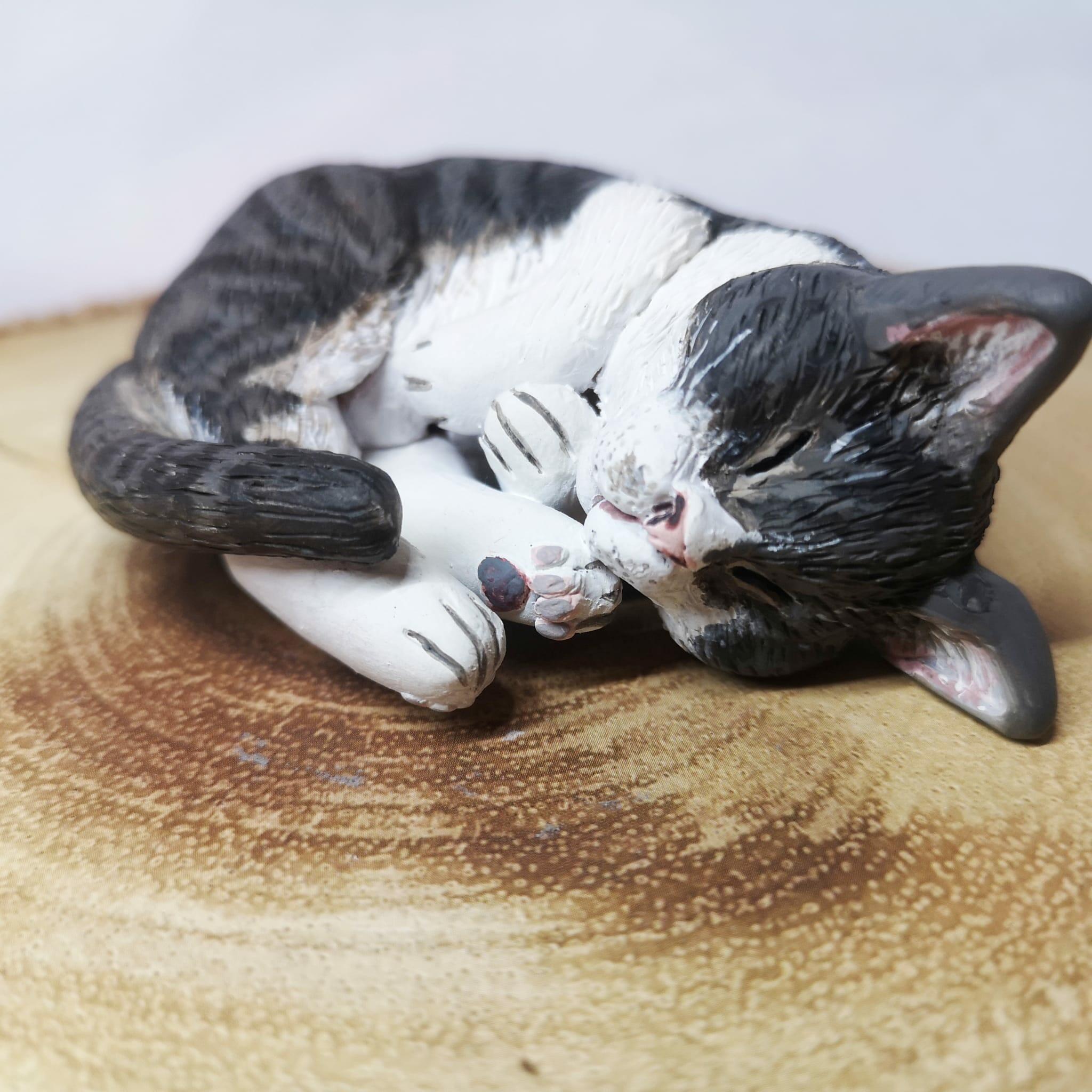 Handmade and handpainted clay model of a sleeping cat, showcasing a lifelike and serene representation of your feline friend, crafted with care and personalized to capture their unique personality