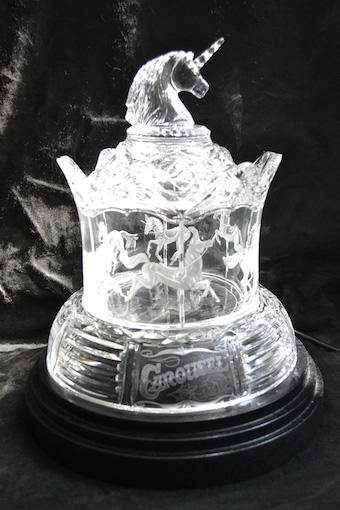 The Unicorn Carousel has six unicorns copper wheel engraved around it. Diamond point work has been done on the lettering and smaller imagery on the lid. When plugged in, the base remains stationary but the unicorn’s rotate. by Greg Sullivan as featured on Eternal Tools' article '5 Glass Engraving Techniques and How They're Done'