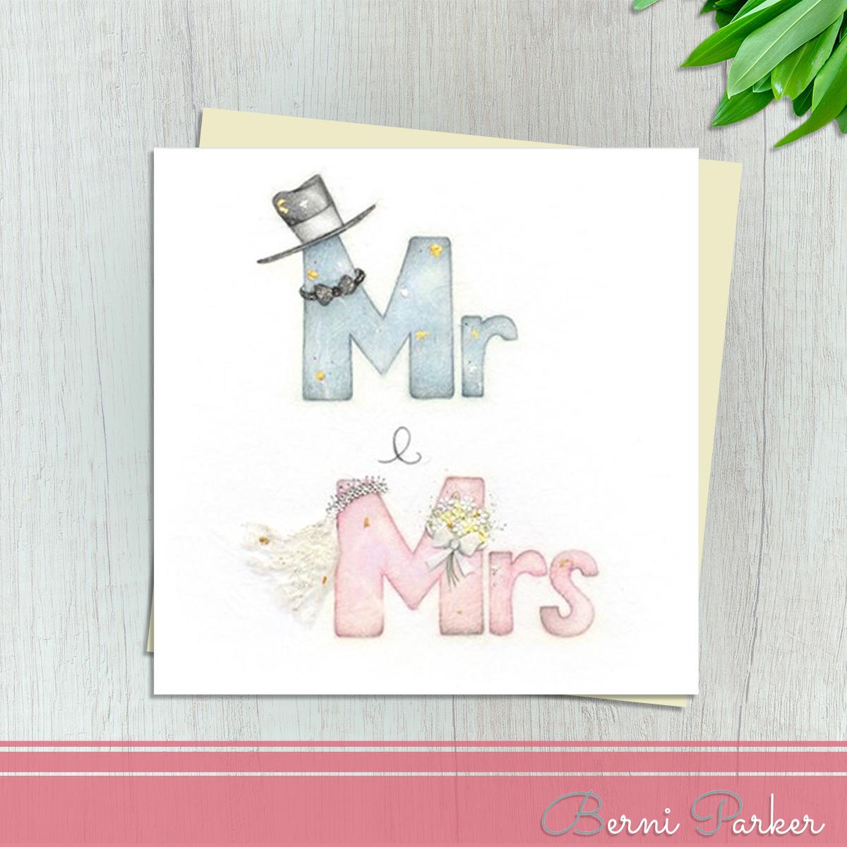 A Blue Mr With A Top Hat And Bow Tie and A Pink Mrs With A Veil And Bouquet Makes This Wedding Day Card So Pretty! With Gold And Silver Accents And Ivory Envelope