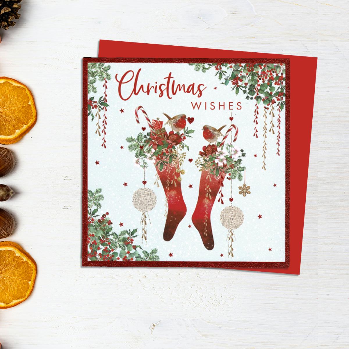 Christmas Wishes Card Showing Two Stockings With Candy Canes And Robins. Finished With Red Lettering And Glitter. A Red Envelope Completes The Look