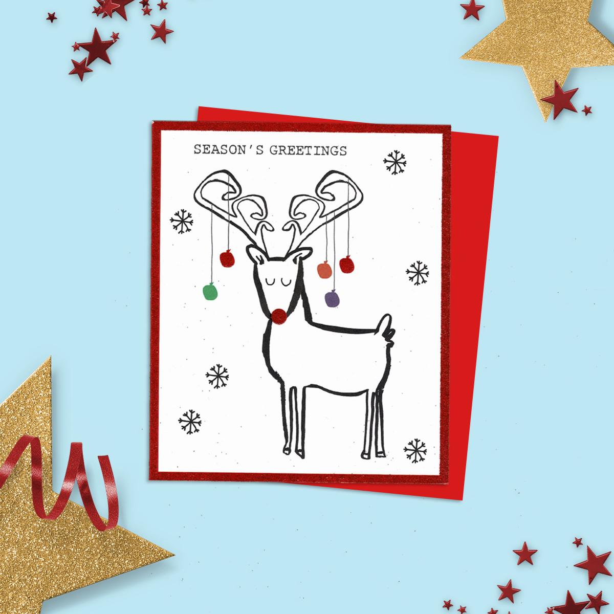 General Christmas Card Featuring A Doodled Reindeer With Christmas Lights On His Antlers! Added Glitter and Red Envelope To Complete