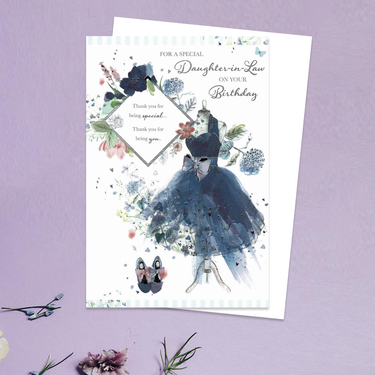 For A Special Daughter In Law On Your Birthday Showing A Beautiful Blue Cocktail Dress On A Stand With Blue Shoes And Flowers. Complete With White Envelope