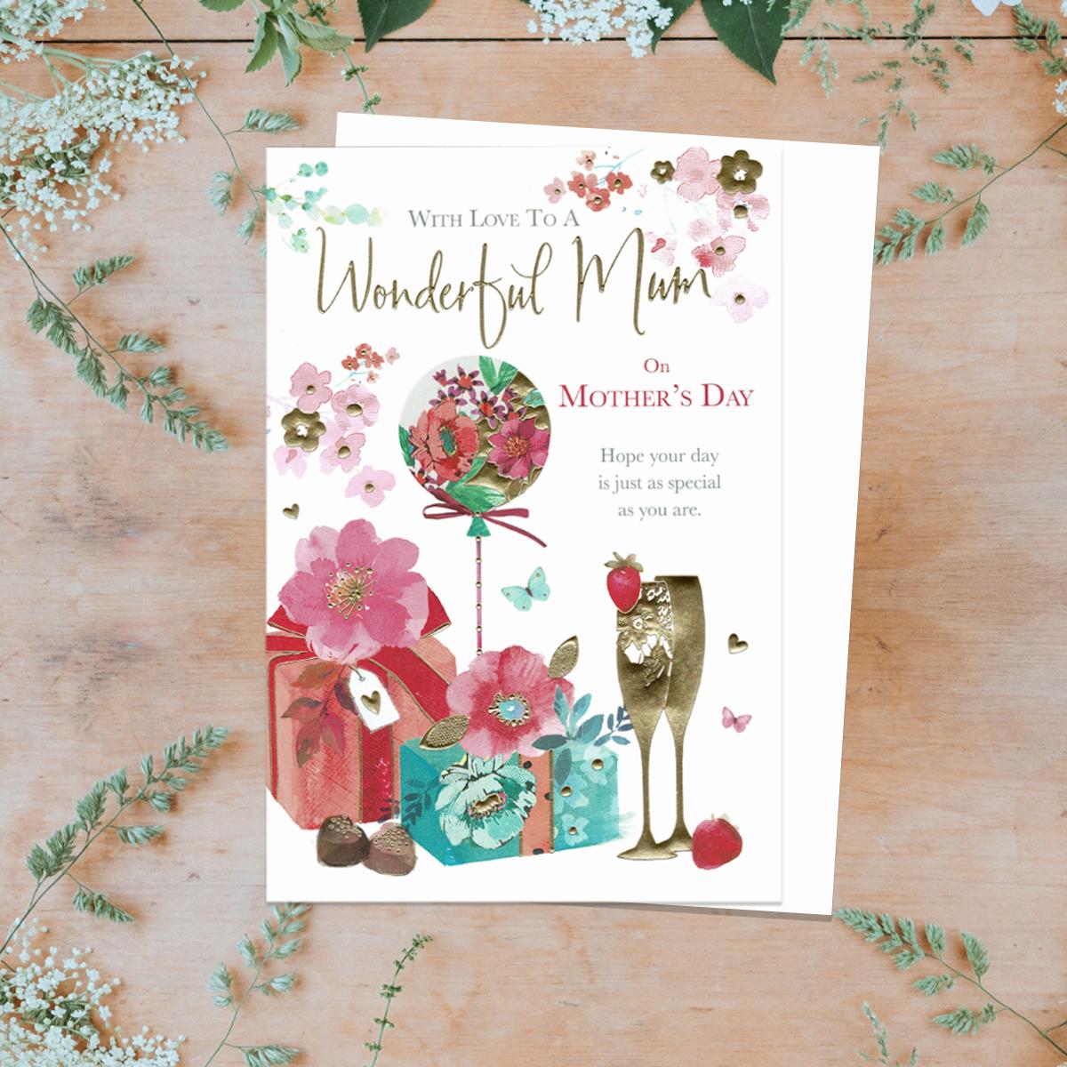 'With Love To A Wonderful Mum On Mother's Day' card showing a balloon, gifts and flutes. Beautiful Colour and gold foil detail with white envelope