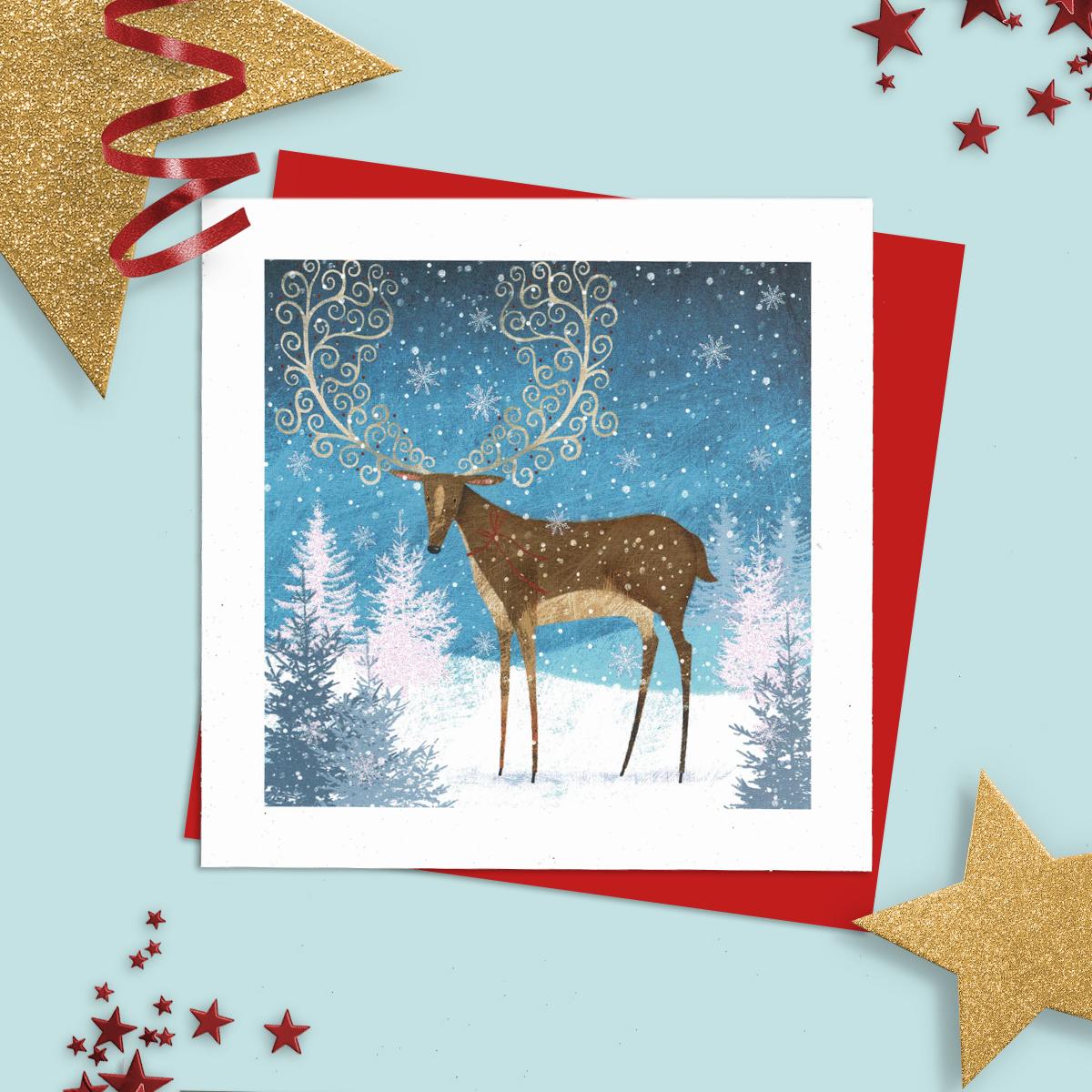 General Christmas Card Featuring A Reindeer In Winter With Beautiful Decorated Antlers. Added Sparkle And Red Envelope To Finish
