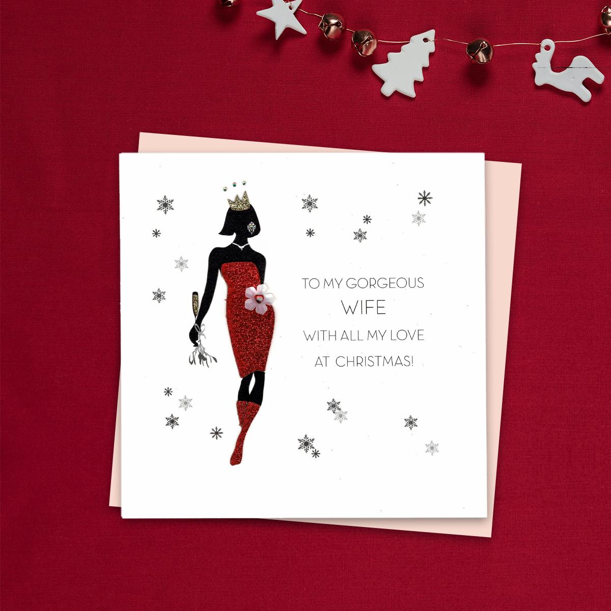 To My Gorgeous Wife With All My Love At Christmas Featuring A Lady Dressed In Red Sparkly Dress And Boots And Gold Party Hat! Finished With Decoupage, Gold Glitter Detail  And Jewel Embellishments, This Handcrafted Card Is Stunning. Blank Inside For Your Own Message. Blush Coloured Envelope