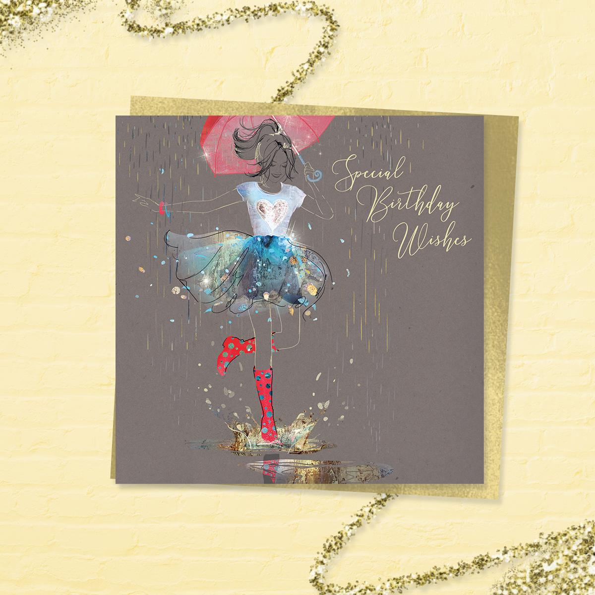 Beautiful 'Special Birthday Wishes' Card From The 'Grace' Range. Featuring A Young Lady In T Shirt And Frothy Skirt With Long Red Boots, Stepping Into A Puddle! With Added Sparkle And Gold Foil Detail. Colour Image Inside With Greeting: Happy Birthday. Complete With Gold Colour Envelope