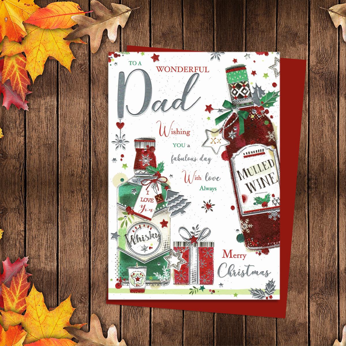 To A Wonderful Dad Merry Christmas Featuring A Bottle Of Whisky And Mulled Wine. Finished With Silver Foil Details And Red Glitter. A Red Envelope Completes The Look!