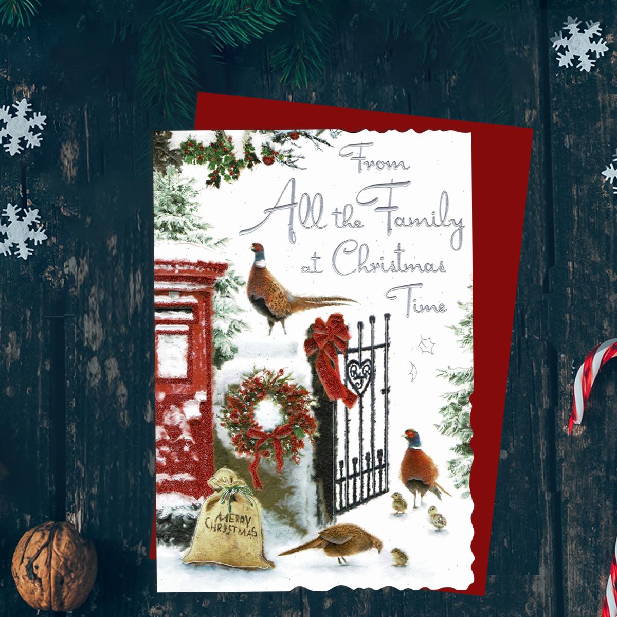 From All The Family At Christmas Time Featuring A Snowy Country Scene! Finished With Silver Foiled Lettering, Red Glitter Details, Red Envelope And Printed Insert