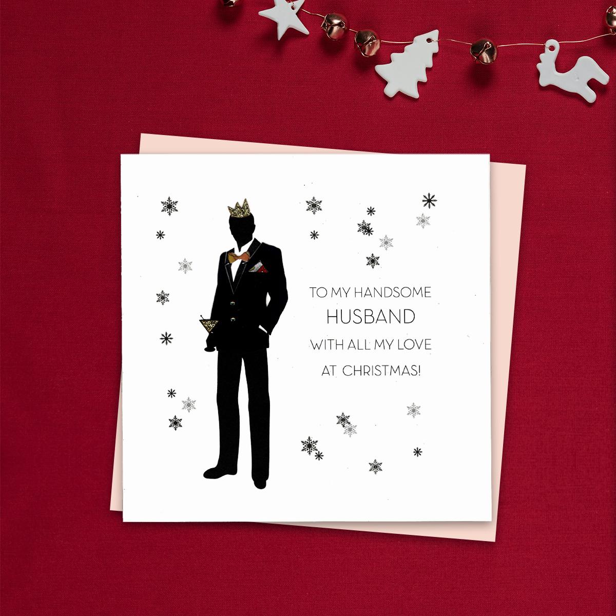 To My Handsome husband With All My Love At Christmas Featuring a Man In Silhouette, Dressed To Kill And Ready To Party! Gold Glitter detail And jewel Embellishments Complete This Stunning, Handcrafted Design. Blush Coloured Envelope And Blank Inside For Your Own Message.