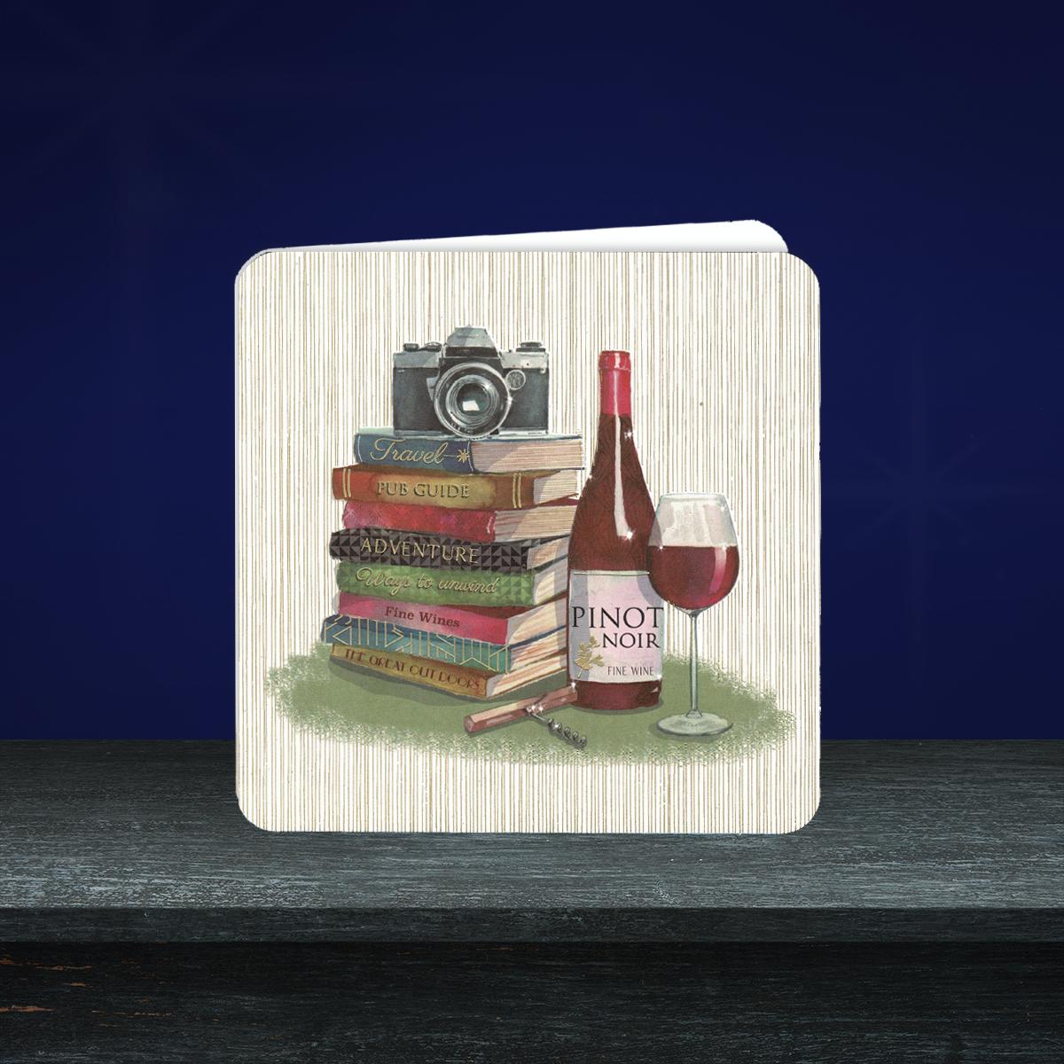 Pizazz Range Blank Card featuring Red Wine, Books And Camera. With Added Gold Foil Detail And Light Blue Envelope