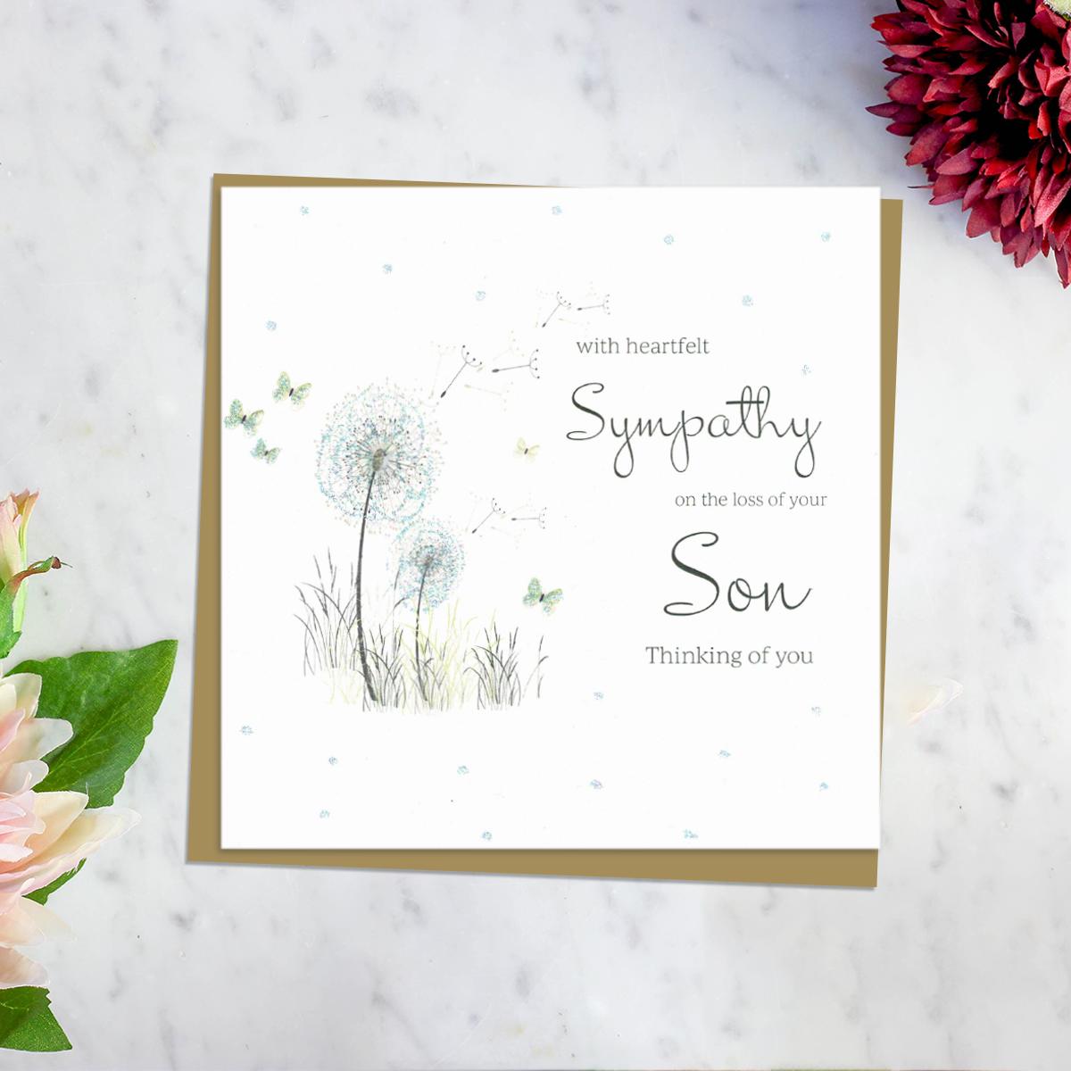 ' With Heartfelt Sympathy On The Loss Of Your Son Thinking Of You' Card Featuring A Dandelion Blowing In The Wind With Surrounding Butterflies. Complete With Brown Envelope And Blank Inside for Own Message