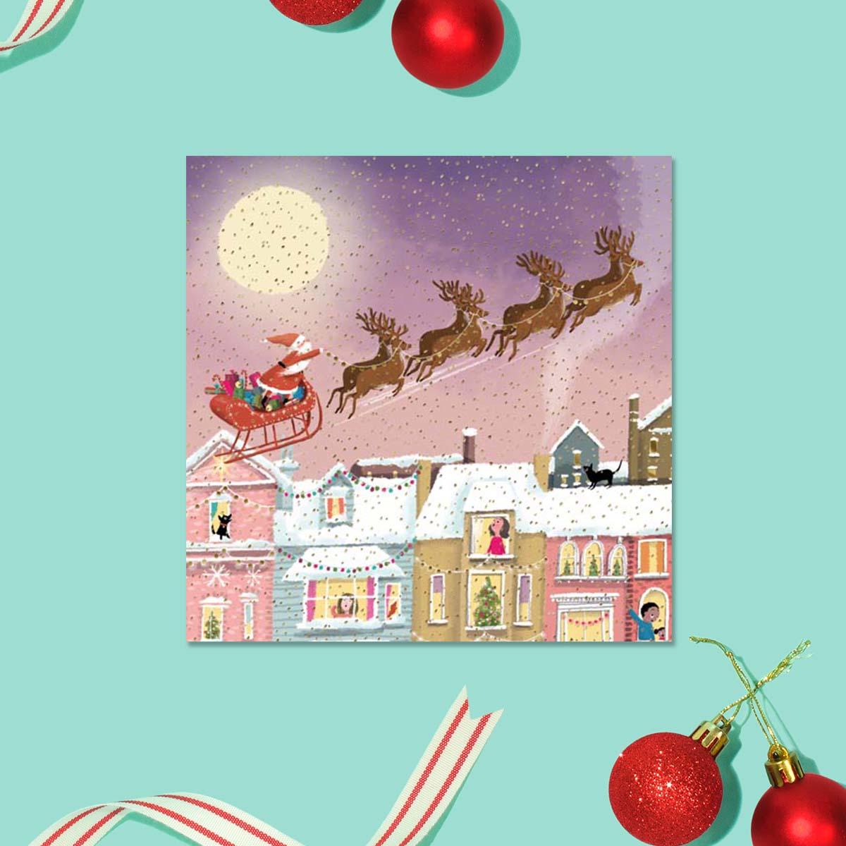 Santa And Sleigh Over the Rooftops Card Front Image