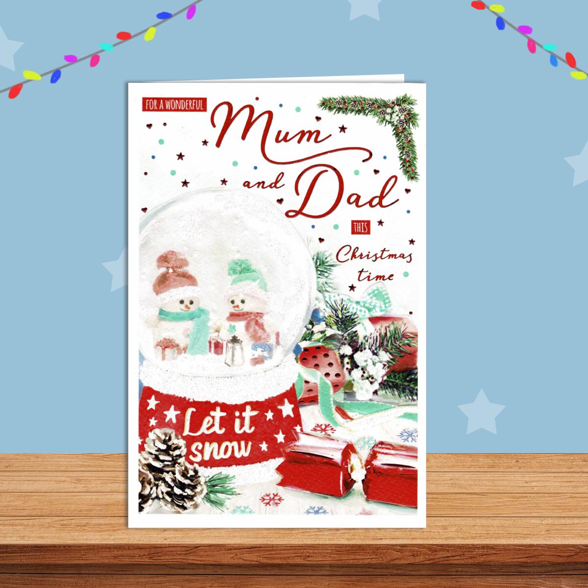 Mum And Dad Christmas Card Alongside Its Red Envelope