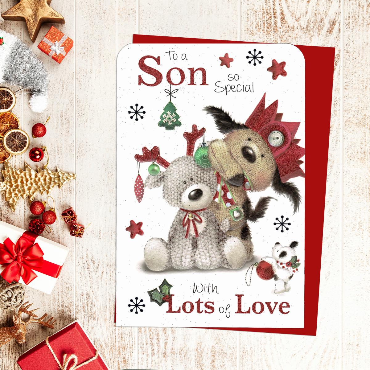 To A Son So Special With Lots Of Love Featuring Two Dogs Decorated With Party Hat And Baubles. Red Glitter Lettering And Red Envelope