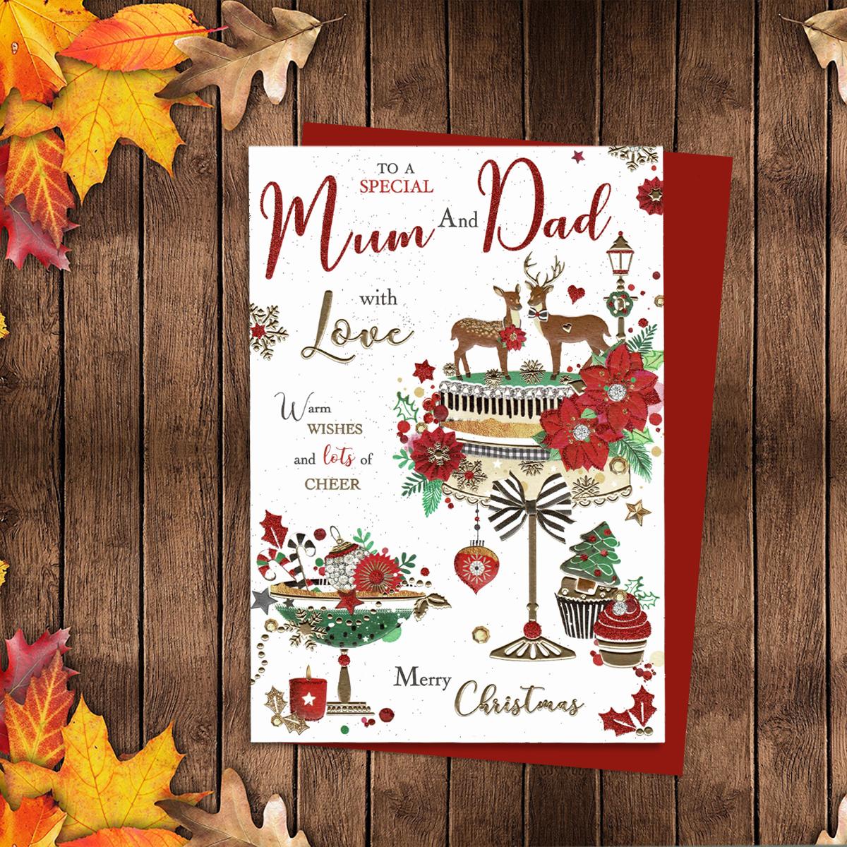 To A Special Mum And Dad With Love Featuring A Beautiful Christmas Cake On A Cake Stand. Finished With Red Glitter, Gold Foiling And A Red Envelope