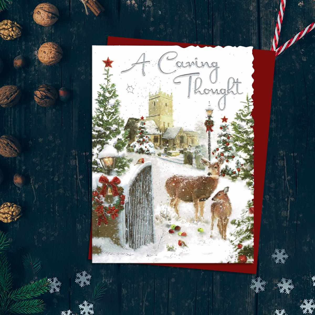 A Caring Thought Featuring A Church With Deer In Snowy Grounds. Finished With Silver Foiled Lettering, Red Glitter Detail And Red Envelope