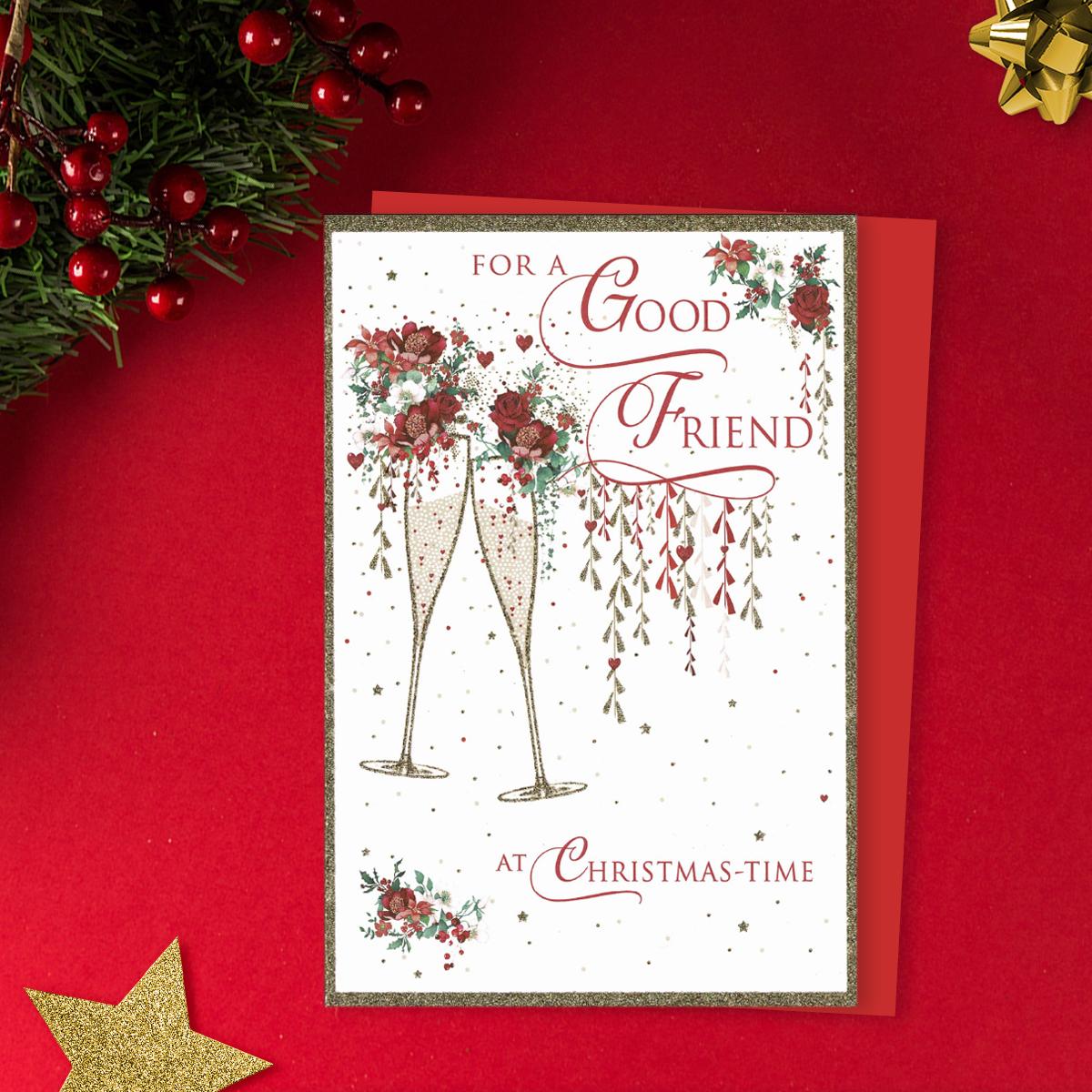 For A Good Friend At Christmas-Time Featuring Two Champagne Flutes Filled With Red Roses. Finished With Gold Sparkle And Red Envelope