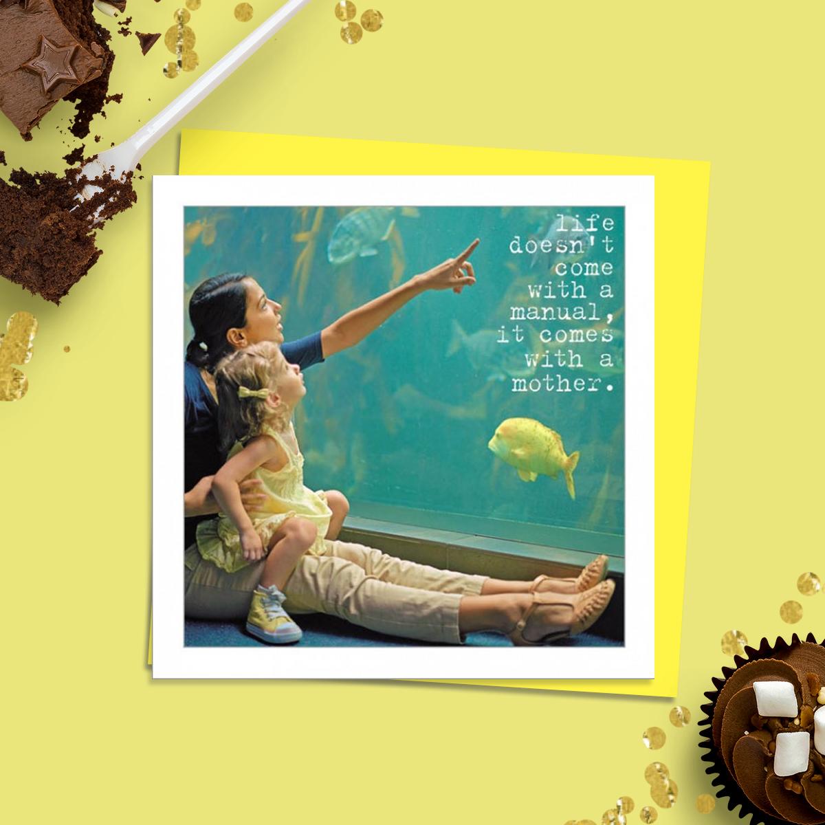 Beautiful Photographic Funny Card Showing A Young Girl With Mother Pointing Into An Aquarium At The Fish. Caption: Life Doesn't Come With a Manual, It Comes with A Mother. Message Inside: With Love. Complete With Neon Yellow  Envelope