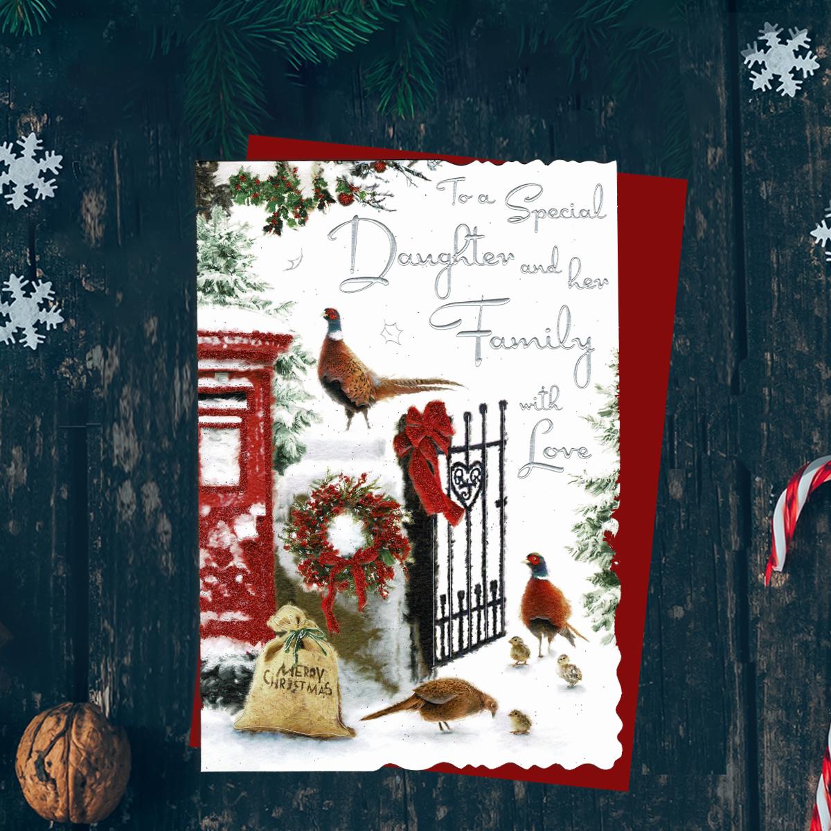 To A Special Daughter And Her Family With Love Featuring A Snowy Country Scene. Finished With Silver Foiled Lettering, Red Glitter Details, Red Envelope And Printed Insert