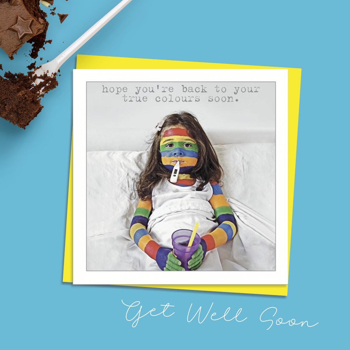 Get Well Card With A Touch Of Humour Showing A Girl In Bed With A Thermometer In Her Mouth. Her Face And Arms Are Coloured In Rainbow Stripes. Caption: Hope You're Back To Your True Colours Soon. Message Inside: Get well Soon. Complete With Neon Yellow Envelope