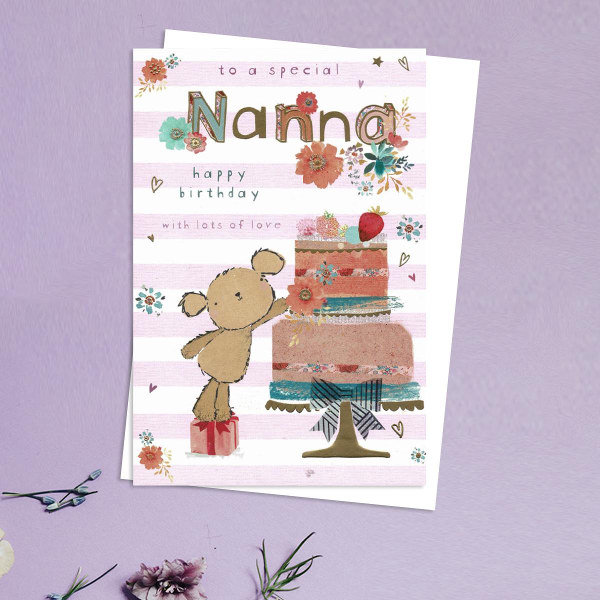To A Special Nanna Happy Birthday Design Showing A Teddy Reaching Up To A Large Cake On A Stand. With Gold Foil Detail And White Envelope