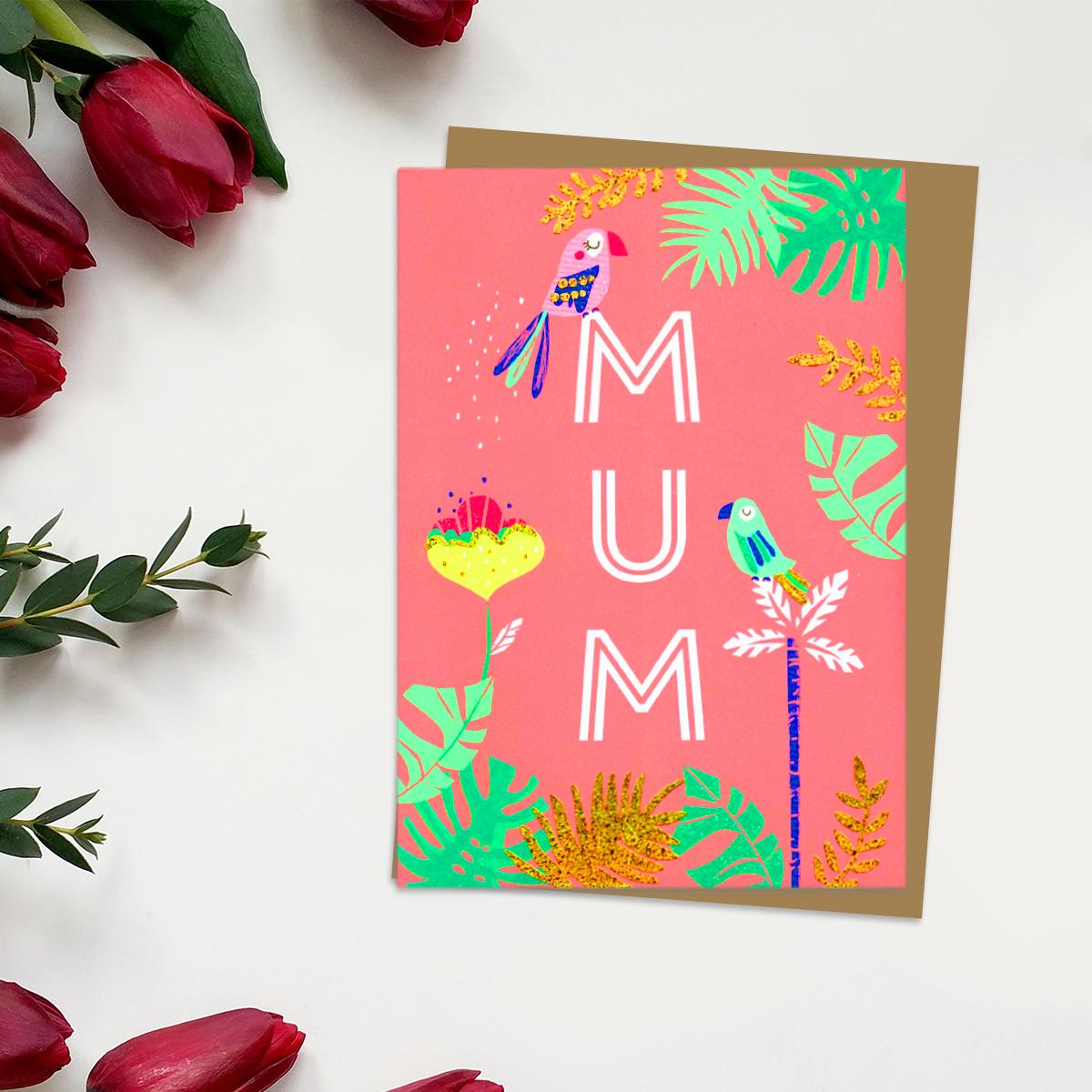 ' Mum' Mother's Day Card In Neon orange Showing A Parrot sitting On Top Of the Letters Of 'Mum'. With Added Gold Foil Detail And Brown Envelope