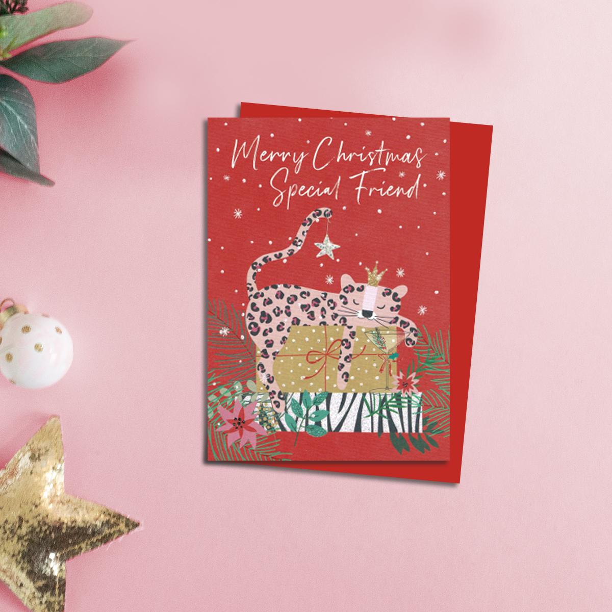 Pink Leopard Friend Christmas Card Alongside Its Red Envelope