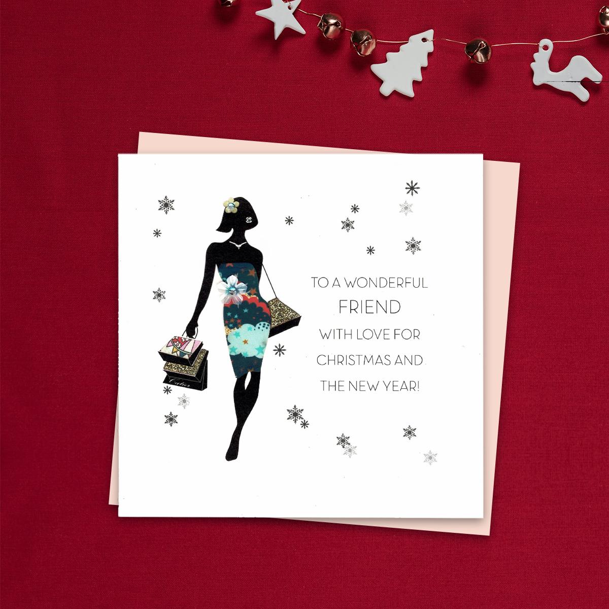 To A Wonderful Friend With love For Christmas And The New Year Featuring A Lady In Silhouette With Decoupage Dress , Carrying Shopping. This Beautiful Handcrafted Card Is Finished With Gold Glitter Accents And Jewel Embellishments. Blank inside For Own Message . With Blush Pink Envelope