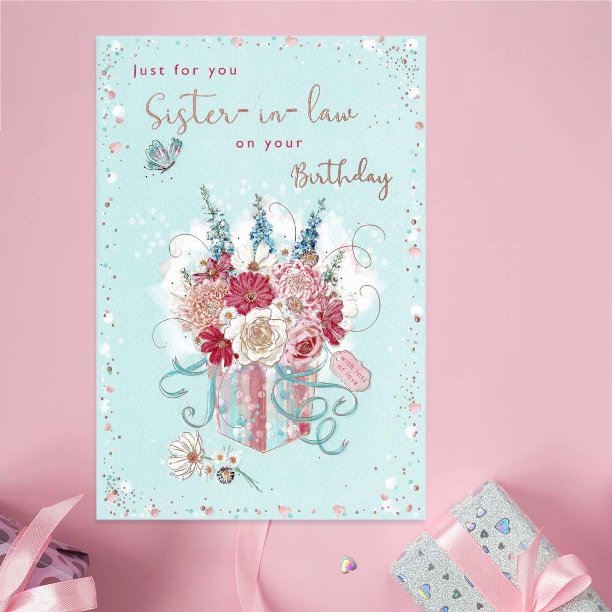 Sister In Law Floral Present Birthday Card Sitting On A Display Shelf