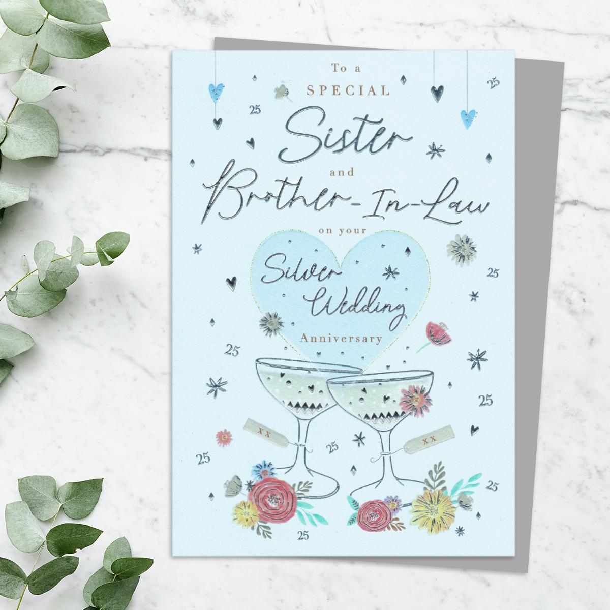 Sister And Brother In Law Silver Anniversary Card Featuring A Champagne Bottle And Glasses To Toast