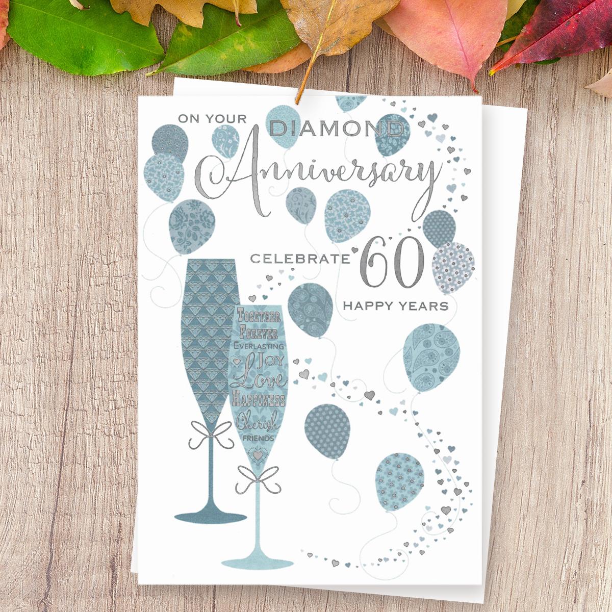 'On Your Diamond Anniversary Celebrate 60 Happy Years' Card Featuring Two Flutes With Balloons. With Beautiful Silver Foil Detail And White Envelope