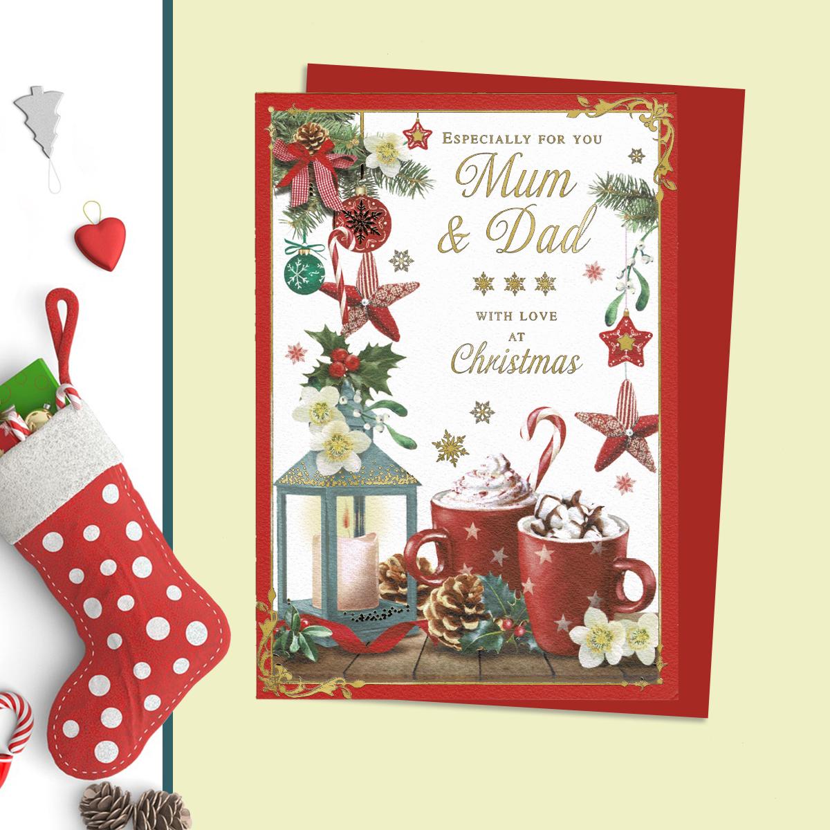 Mum And Dad Christmas Card Alongside Its Red Envelope