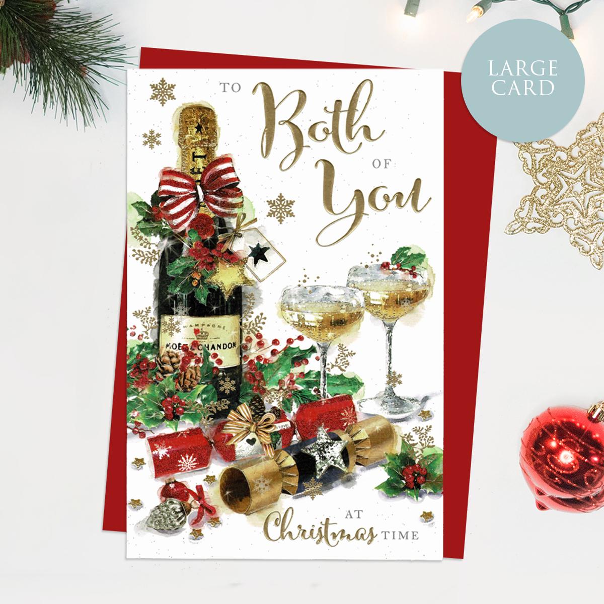 To Both Of You At Christmas Time Featuring A Bottle Of Champagne And Glasses With Christmas Crackers. Finished With Gold Lettering, Red Glitter and Red Envelope