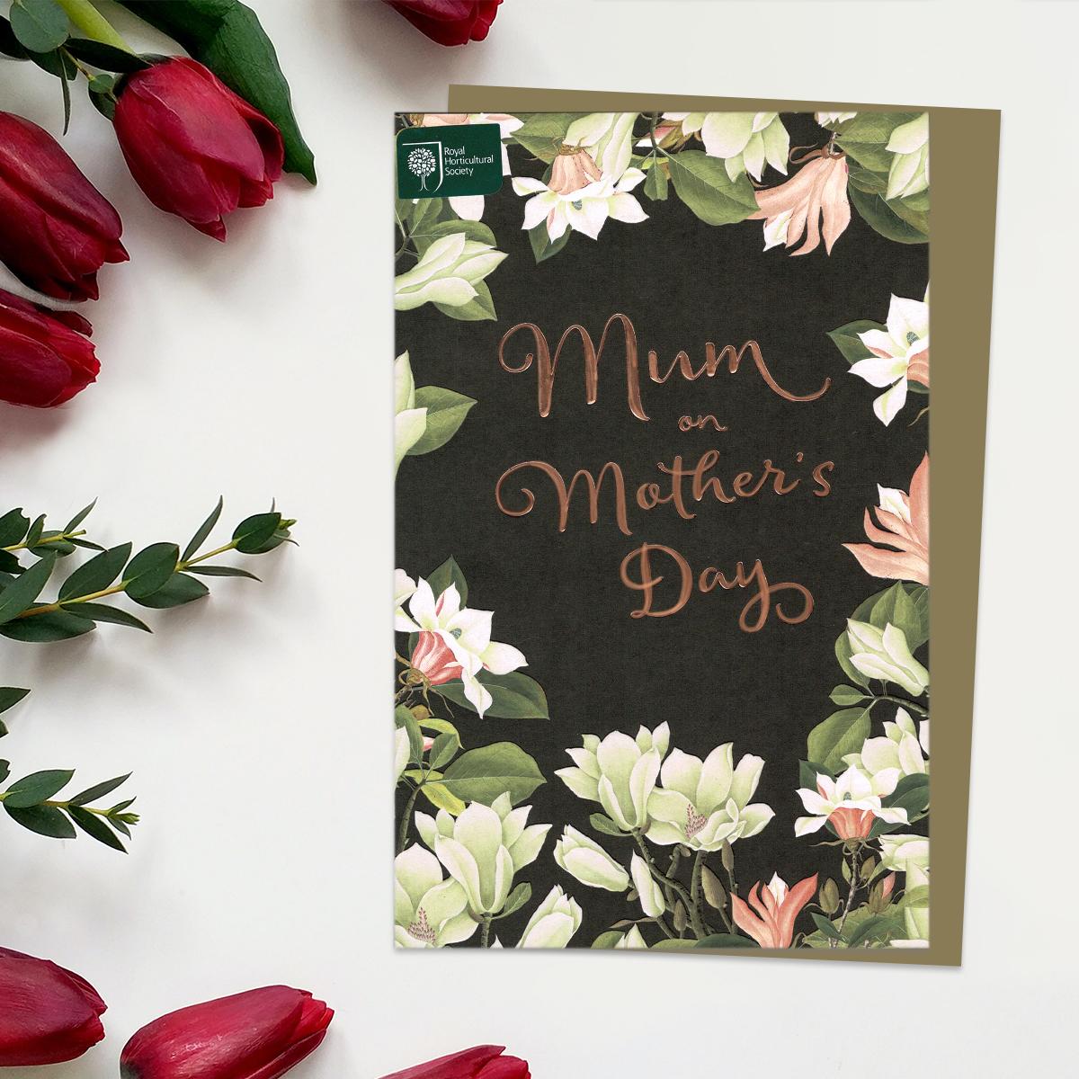 ' RHS Mum On Mother's Day' Card Featuring A Black Background With Beautiful Flowers Creating A Border. With Brown Envelope