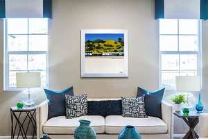 Stylish living room with a colourful painting of the beach huts in Bournemouth England