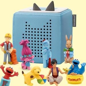 Blue Tonie Box with various Tonies characters around including Bob The Builder, Poppy from Trolls, Elmo, Spot The Dog and Peter Rabbit. Pale yellow background.