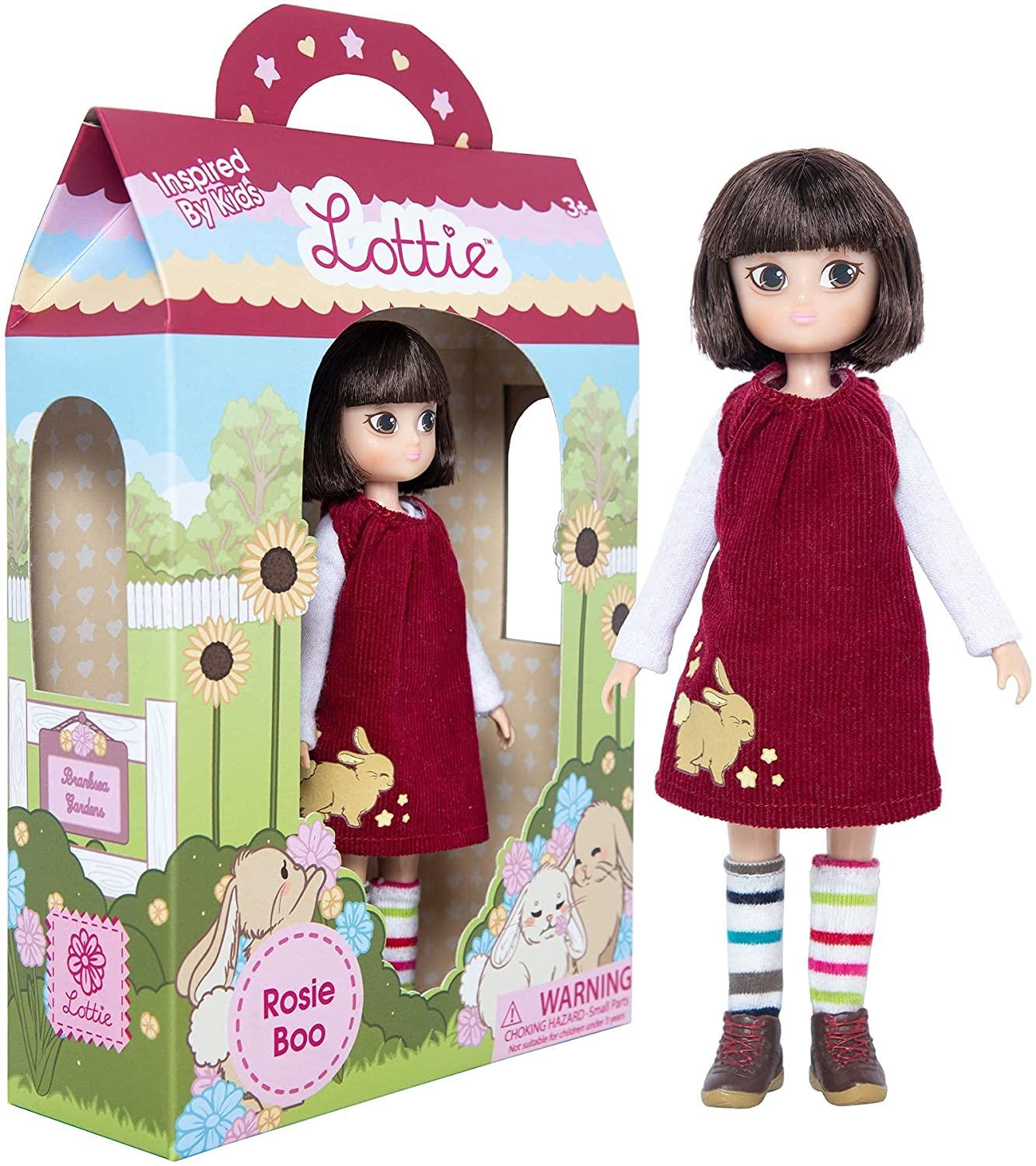 Rosie Boo Lottie Doll in red dress, stripy socks standing beside the box.