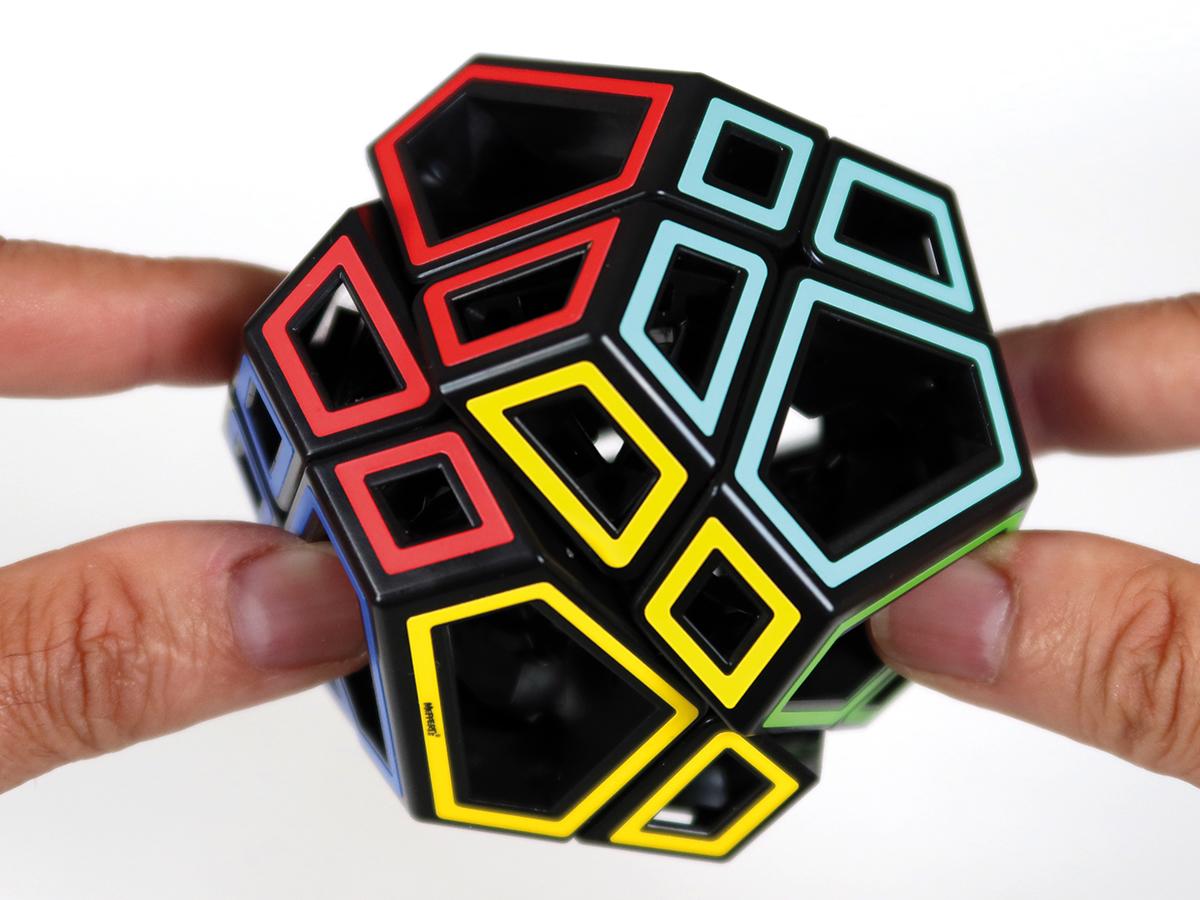 Hands holding the Hollow Skewb Ultimate puzzle.
