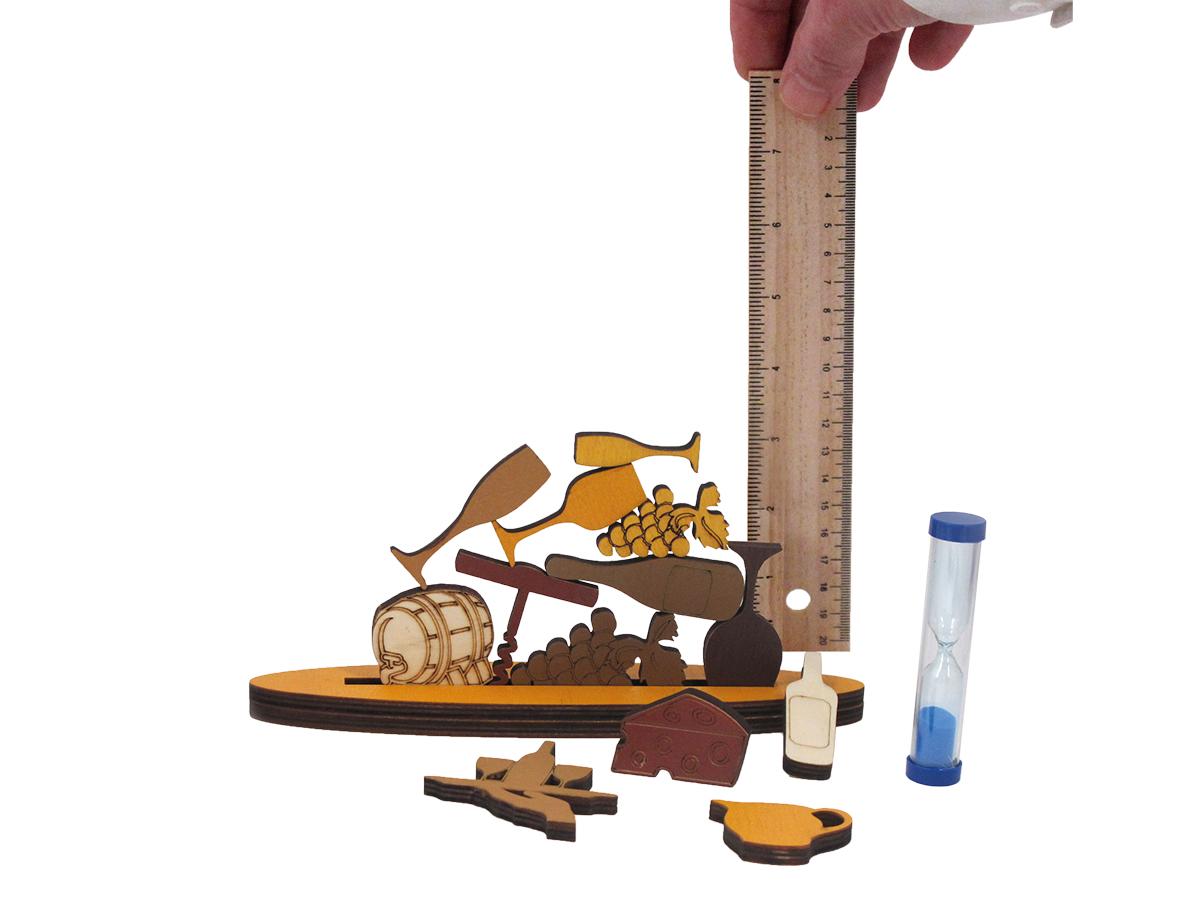 Wooden stacking game with pieces shaped like bottle, bunches of grapes and wine glasses with the height being measured by a wooden ruler.