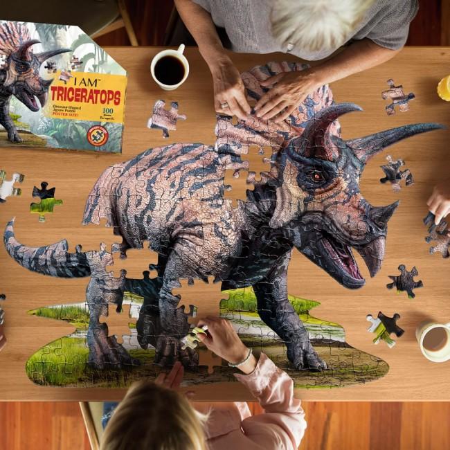Image taken from above showing people working on the large triceratops puzzle.