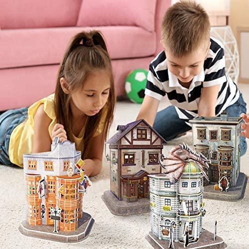 A boy in a dark blue and white stripey top and a young girl with long dark hair and a yellow top lying on her front looking at the four Harry Potter 3D puzzle buildings.