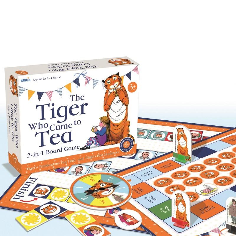 The Tiger Who Came to Tea board game box sitting atop the board and showing the upright tiger pieces of the game.