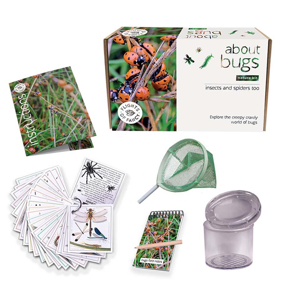 Content of the About Bugs kit including magnifying glass and notebook. White background.