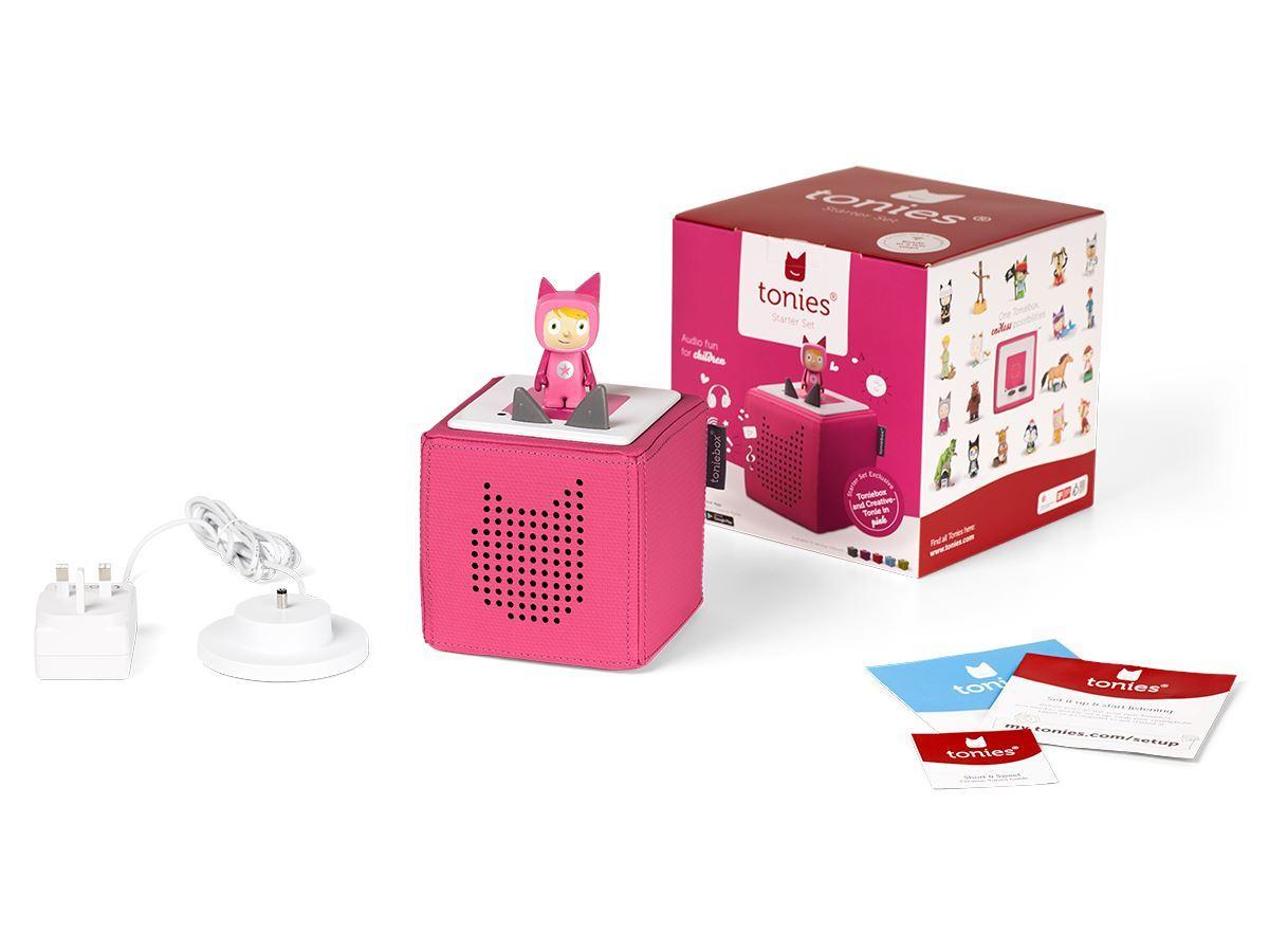 Pink Toniebox with charging station and instructions beside the manufacturer's packaging