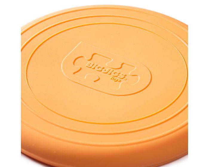 Close-up section of a pale orange frisbee.