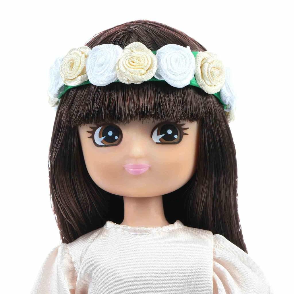 Close-up of Flower Girl Lottie Doll's face. White background.
