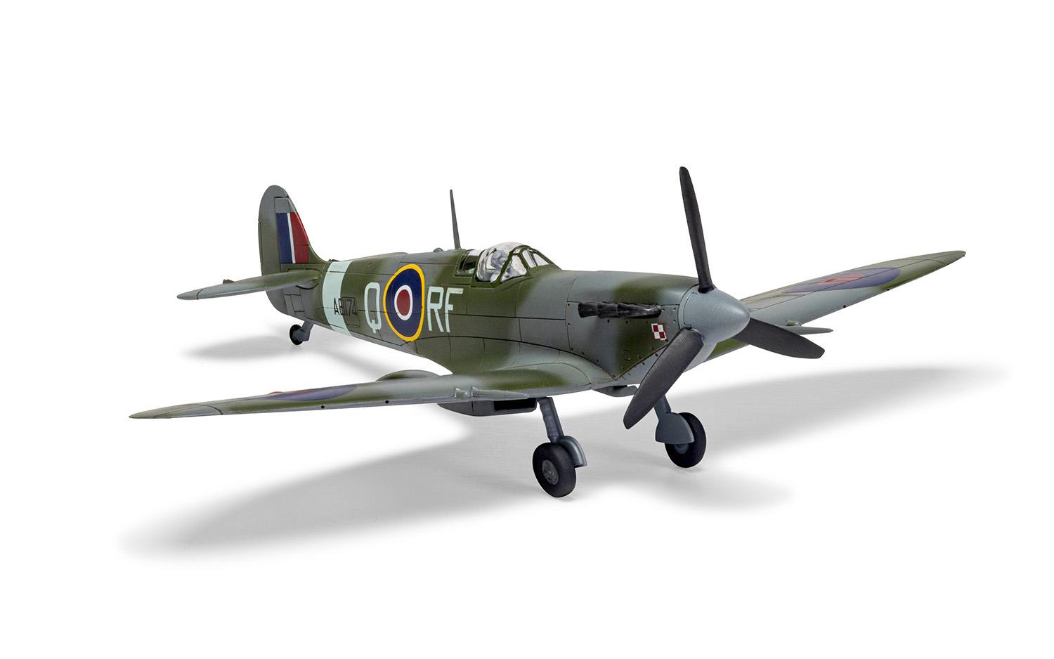 Scale model of a Spitfire airplane on a white surface. White background.