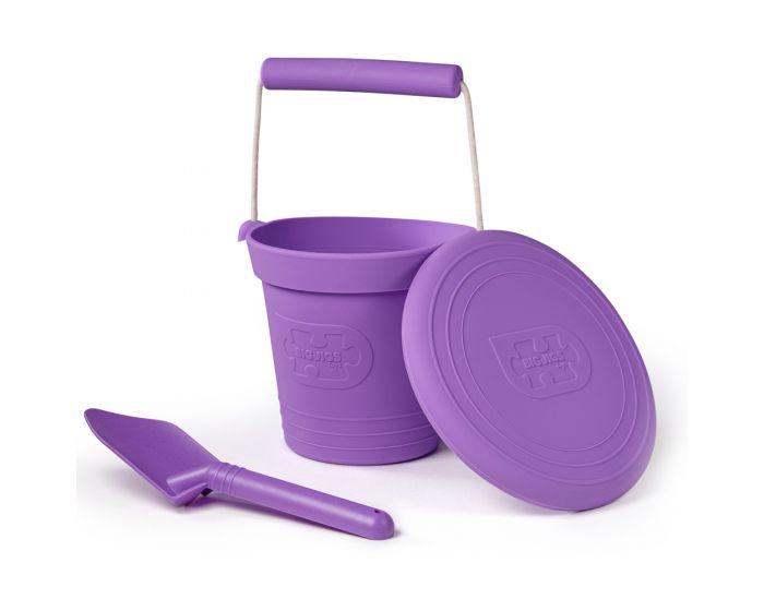 Purple bucket, spade and frisbee. White background.